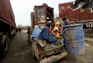 In Wednesday, March 11, 2015 photo, an Afghan refugee family return to Afghanistan through Pakistan's border crossing, Torkham, east of Kabul, Afghanistan. Since January, almost 50,000 Afghan families have passed through Torkham, double the amount of all refugees returning through the border town in 2014, according to the International Organization for Migration. Many say they fled Pakistan over increased harassment by police who told them to return to Afghanistan, a country many have never even seen, putting new pressure on both countries to find solutions to the decades-old flow of refugees. (AP Photo/Rahmat Gul)