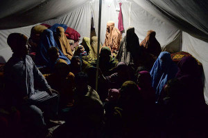 In this photograph taken on January 18, 2017, internally displaced women with their children sit inside their tent on the outskirts of Jalalabad. Marooned in a tent billowing in the winter wind, Gul Pari's family is among thousands of war-displaced Afghans crammed into settlements alongside a flood of returning refugees, in a double-pronged humanitarian crisis engulfing the country. Conflict-torn Afghanistan is struggling to reabsorb large masses of refugees and failed asylum seekers being sent back from Pakistan, Europe and Iran, joining more than half a million others uprooted by war. / AFP PHOTO / NOORULLAH SHIRZADA / TO GO WITH 'Afghanistan-Unrest-Refugees-Social' FOCUS by Anuj CHOPRA